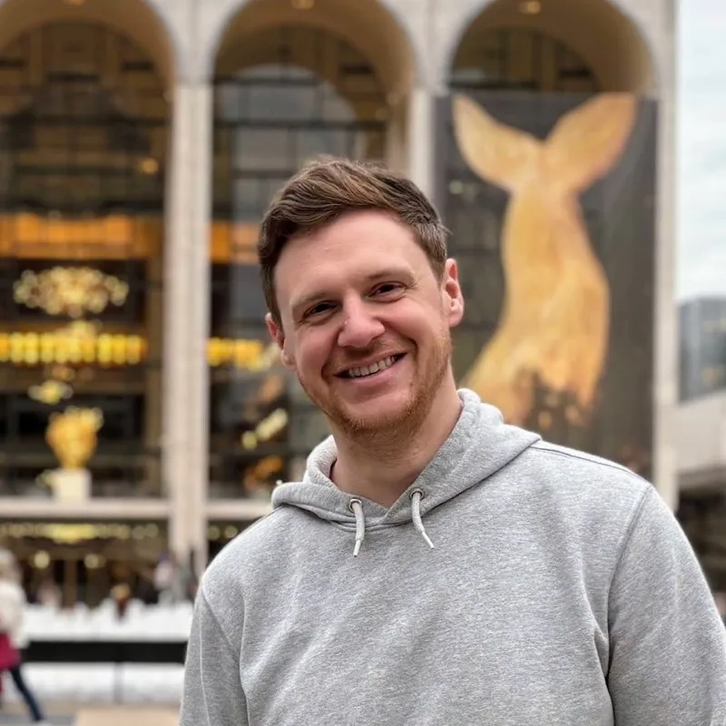 Brian smiling in front of Lincoln Center